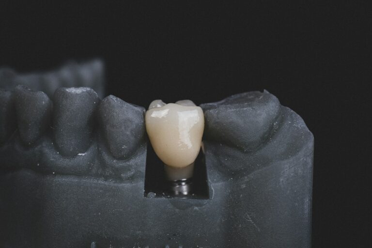 Adult patient reviewing a dental implant scan with a clinician in a bright treatment room.